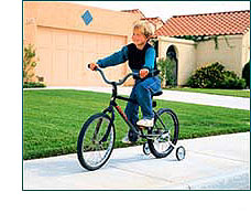 Child with training wheels, riding bike